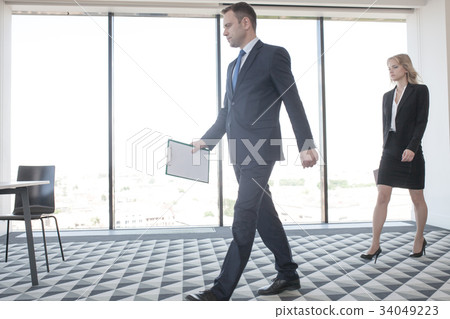Business speaker coming to conference room Business speaker coming to conference room 34049223