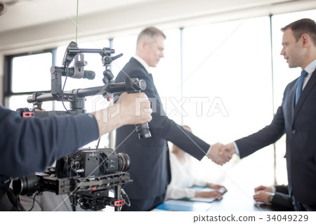 Videographer making video of business people 34049229