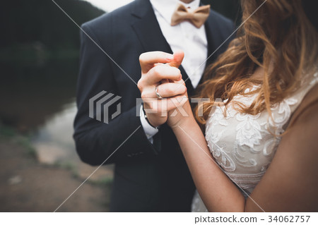 Wedding couple bride and groom holding hands 34062757