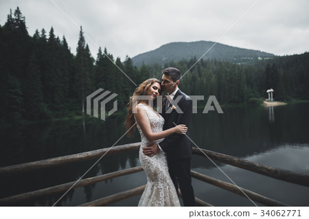 Beautiful gorgeous bride posing to groom and 34062771