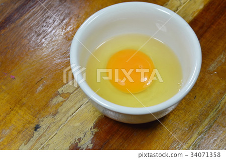 egg yolk in cup on table 34071358