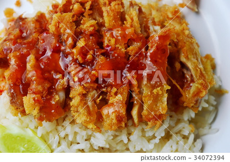 fried chicken on steamed rice dressing sweet sauce fried chicken on steamed rice dressing sweet sauce 34072394