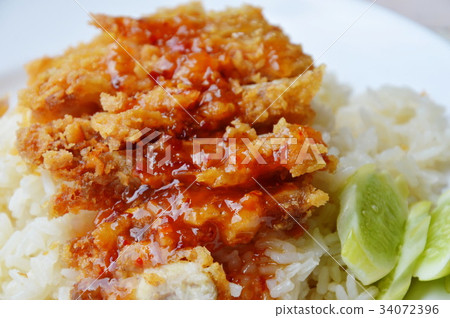 fried chicken on steamed rice dressing sweet sauce 34072396