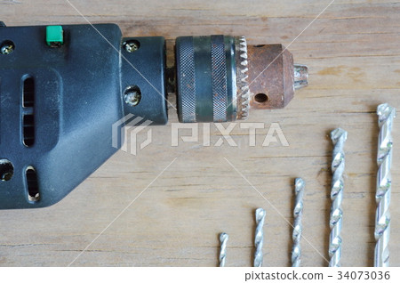 electric drill and different bit on wooden board 34073036
