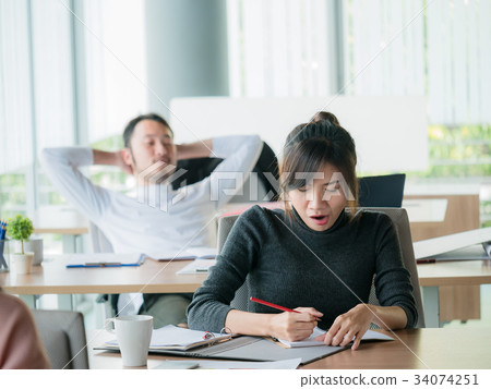 Business woman yawn in office with businessman 34074251