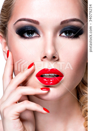 Portrait of beautiful  woman with  red lips and nails. 34079254