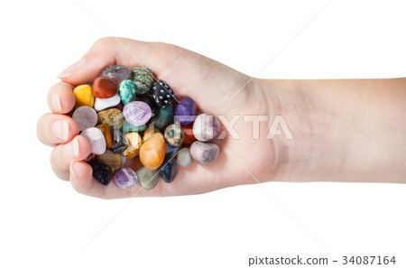 top view of handful with various gems isolated 34087164