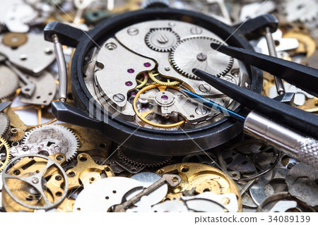 tools on open watch on heap of clock spare parts 34089139