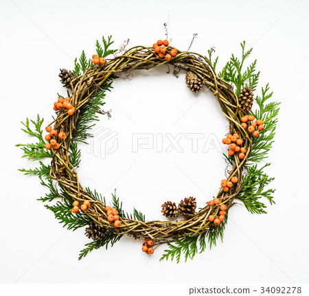 Festive wreath with thuja, berries, cone. Flat lay Festive wreath with thuja, berries, cone. Flat lay 34092278