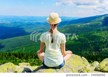 Young travel girl sitting on the rock mountain, relaxing Young travel girl sitting on the rock mountain, relaxing 34098092