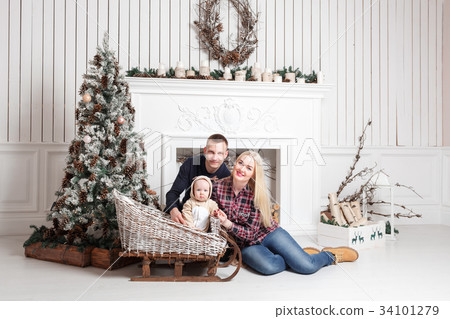 Happy family at Christmas. The parents and the 34101279