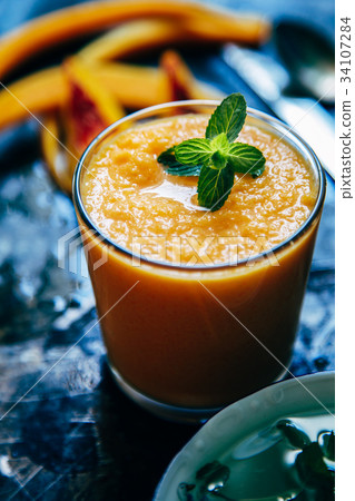 Orange smoothie with leaves of fresh mint Orange smoothie with leaves of fresh mint 34107284