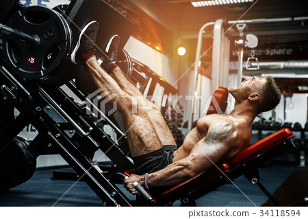 Man Using A Press Machine In A Fitness Club Man Using A Press Machine In A Fitness Club 34118594