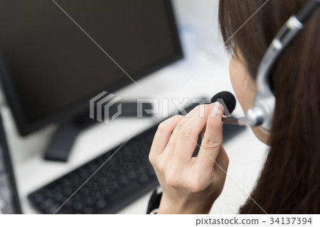 Female employee speaking in headset Female employee speaking in headset 34137394