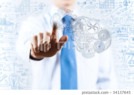 Businessman activating gears mechanism Businessman activating gears mechanism 34137645