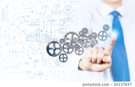 Businessman activating gears mechanism Businessman activating gears mechanism 34137647