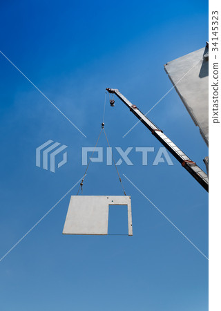 Construction site crane is lifting a precast  wall 34145323