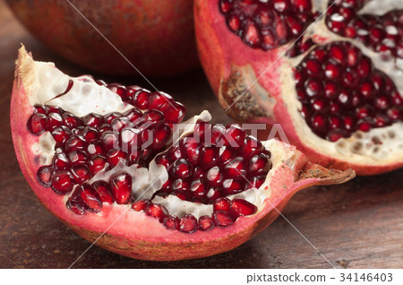 Pomegranate on a timber board 34146403