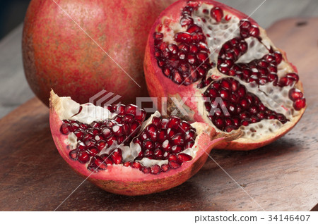 Pomegranate on a timber board Pomegranate on a timber board 34146407