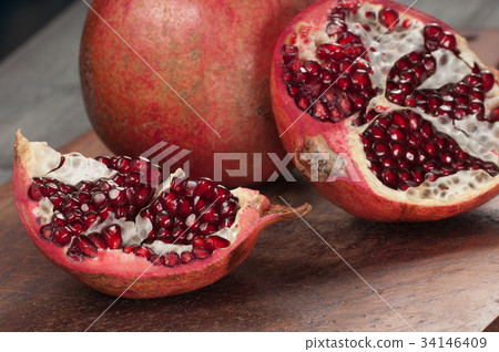 Pomegranate on a timber board 34146409