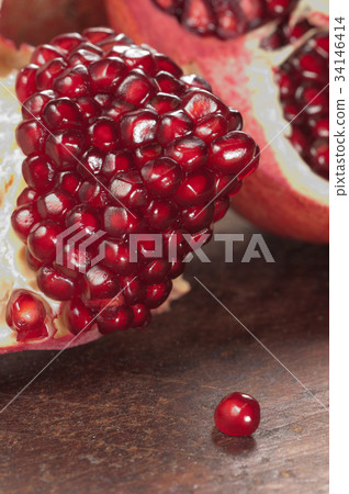 Pomegranate on a timber board 34146414