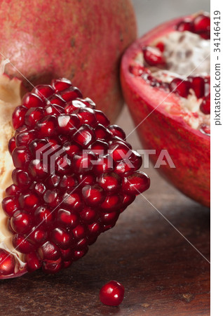 Pomegranate on a timber board Pomegranate on a timber board 34146419