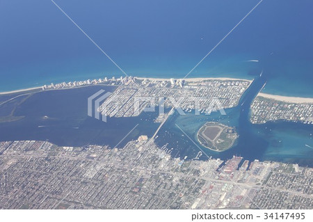 Aerial view of Peanut Island floating on the Atlantic coast of Florida, the city of Riviera Beach, sandbanks and coves Aerial view of Peanut Island floating on the Atlantic coast of Florida, the city of Riviera Beach, sandbanks and coves 34147495