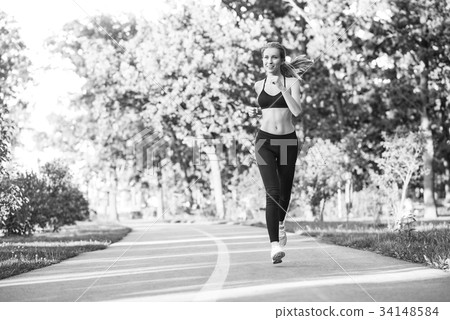 Female runner jogging in the forest 34148584