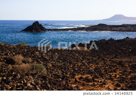 Panoramic ocean view. Volcano, black rocks. Sand 34148925