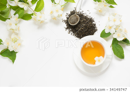 Jasmine flowers and cup of green tea on white. Jasmine flowers and cup of green tea on white. 34149747
