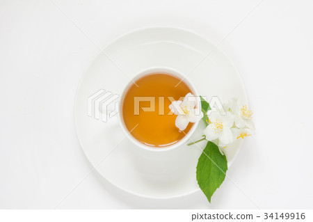 Jasmine flowers and cup of green tea on white. 34149916