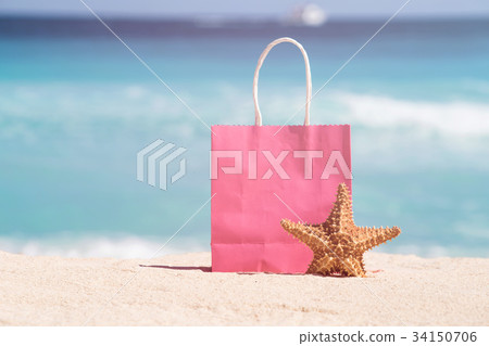Shopping bag and starfish on sand Shopping bag and starfish on sand 34150706