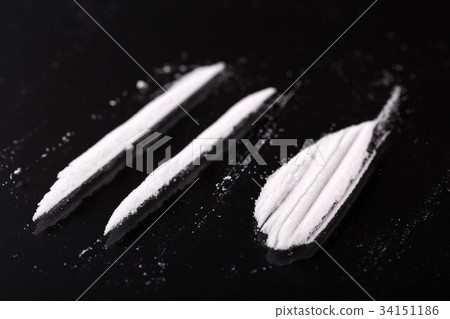 Two lines and pile of cocaine on black background Two lines and pile of cocaine on black background 34151186
