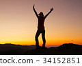 Silhouette of happy young attractive woman jumping 34152851