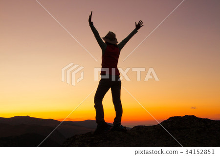 Silhouette of happy young attractive woman jumping 34152851
