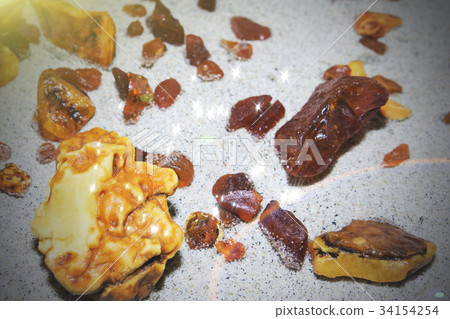 Amber. the pieces of amber in the sand on the Amber. the pieces of amber in the sand on the 34154254