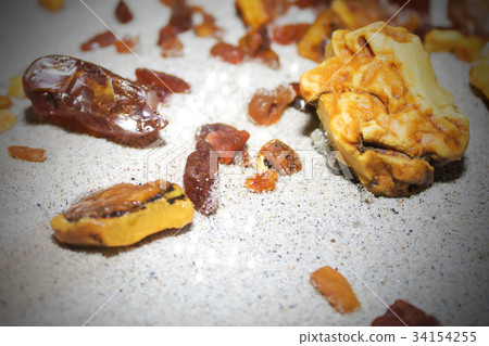 Amber. the pieces of amber in the sand on the Amber. the pieces of amber in the sand on the 34154255