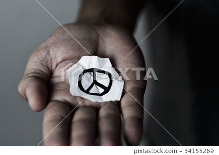 man with a peace symbol in a piece of paper man with a peace symbol in a piece of paper 34155269