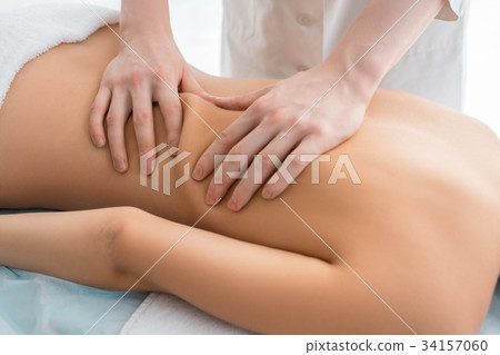 Nude woman being massaged cropped view 34157060