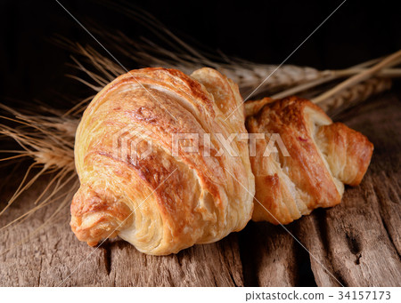 Tasty croissants on wooden background. Tasty croissants on wooden background. 34157173