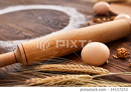 top view eggs, dough, flour and rolling-pin on 34157253