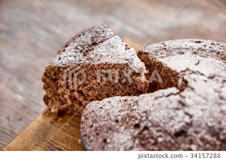 Delicious chocolate cake in white plate on wooden Delicious chocolate cake in white plate on wooden 34157288