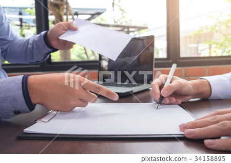 Close up of the hand employer focus the employee to write a lett Close up of the hand employer focus the employee to write a lett 34158895
