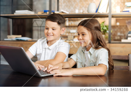 Little brother and sister surfing the web together 34159288