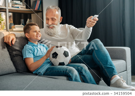 Man turning air conditioning on while watching 34159504