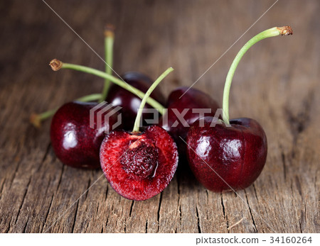 Fresh cherry on wooden background. 34160264