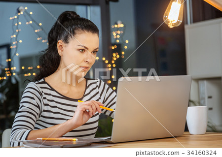 Beautiful nice woman holding a pencil 34160324