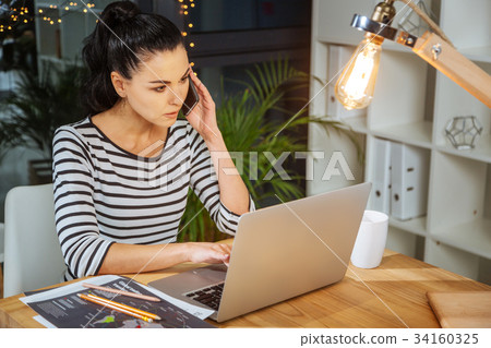 Nice pleasant woman holding a cell phone 34160325