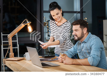 Joyful hard working colleagues looking at the 34160477