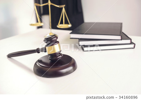 Attorney's suit, Law books, a gavel and scales of justice on a w Attorney's suit, Law books, a gavel and scales of justice on a w 34160896